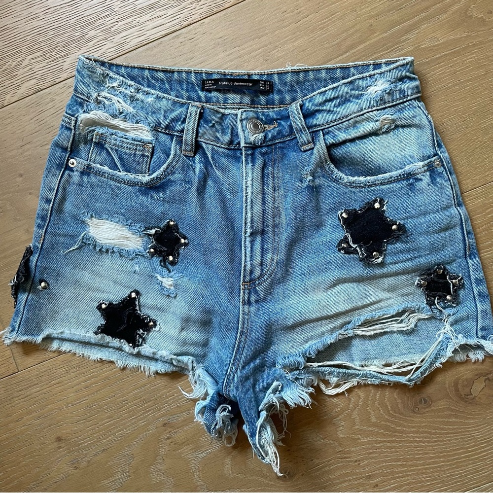 Distressed blue denim shorts with star patch detail